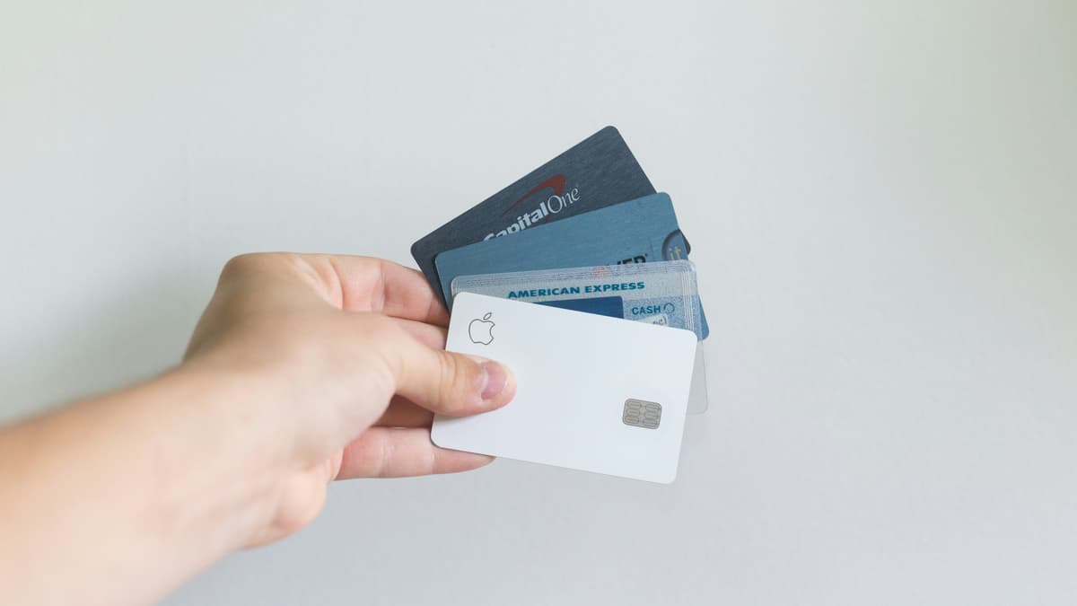 A hand displaying multiple credit cards from various issuers, representing diverse payment methods and financial flexibility.