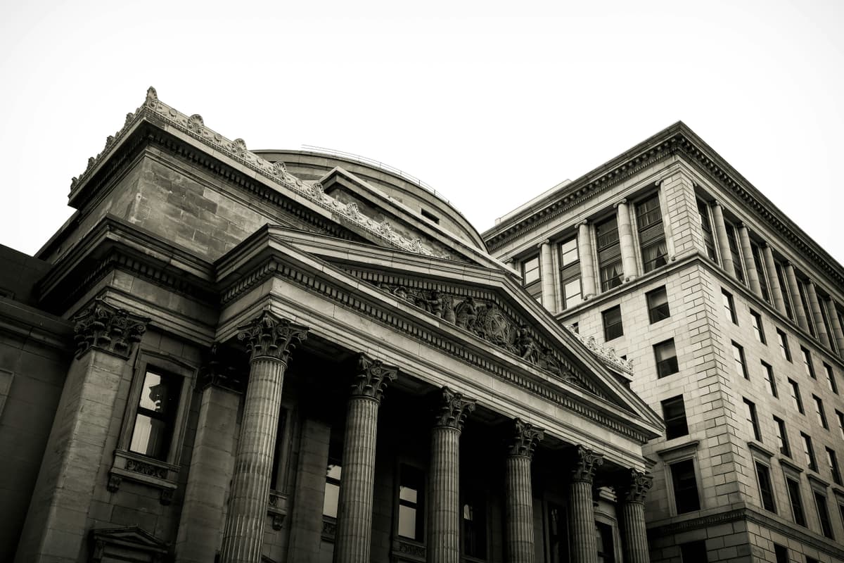 A classic architectural bank building with ornate columns, illustrating the stability and tradition of financial institutions.