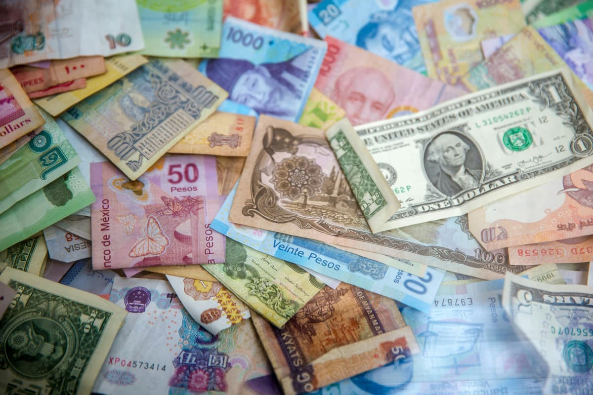 A collection of colorful international currency notes, symbolizing global financial transactions and multi-currency support.