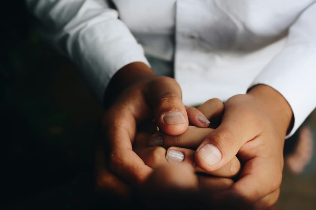 A close-up of a doctor's hands holding a smartphone, showcasing connectivity and telemedicine.