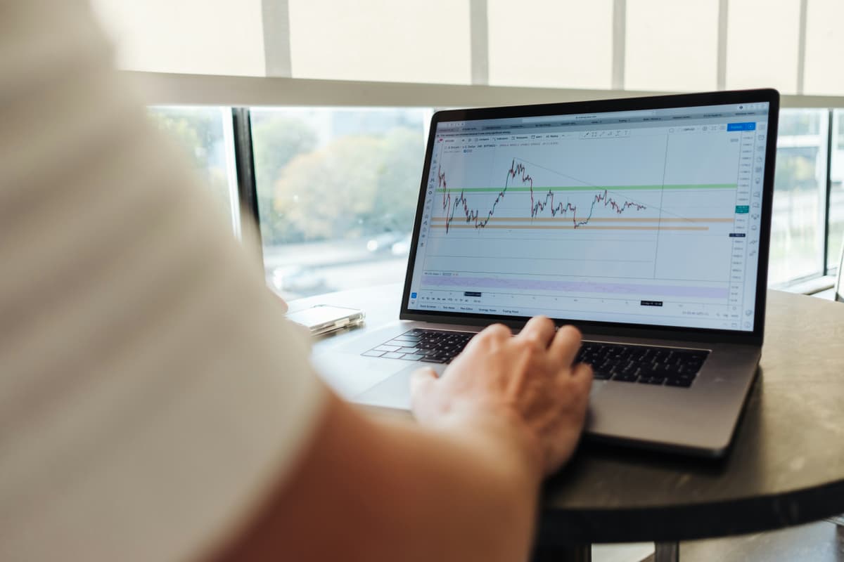 A laptop displaying a trading chart, suggesting financial analysis, online trading, or payment analytics.